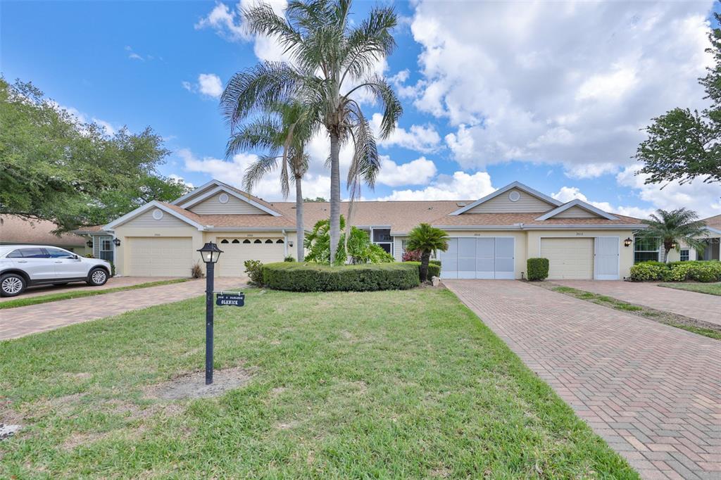 2012 Nantucket Drive, Unit 22 Sun City Center, FL 33573 - Photo 36 of 90 a front view of a house with a yard and garage