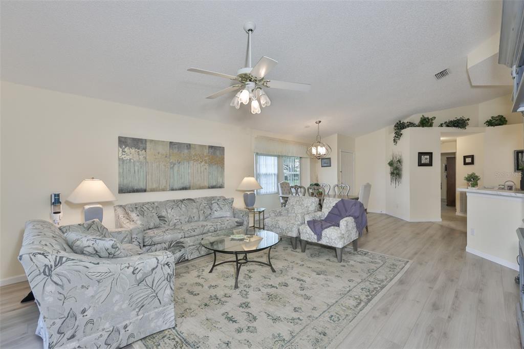 2012 Nantucket Drive, Unit 22 Sun City Center, FL 33573 - Photo 8 of 90 a living room with furniture and a chandelier