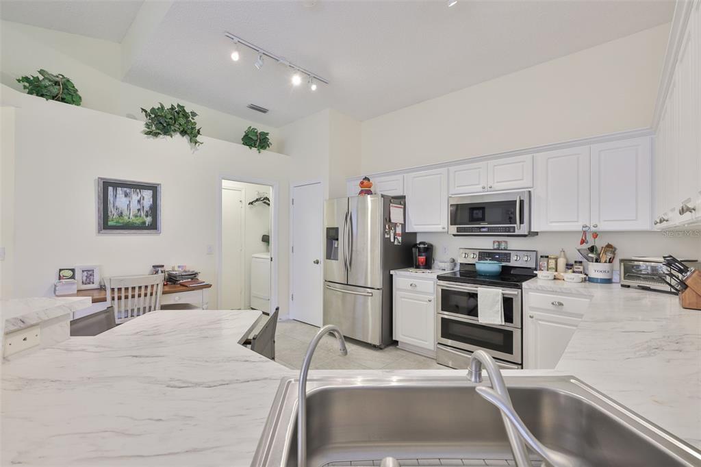 2012 Nantucket Drive, Unit 22 Sun City Center, FL 33573 - Photo 9 of 90 a room with stainless steel appliances kitchen island granite countertop a sink and cabinets