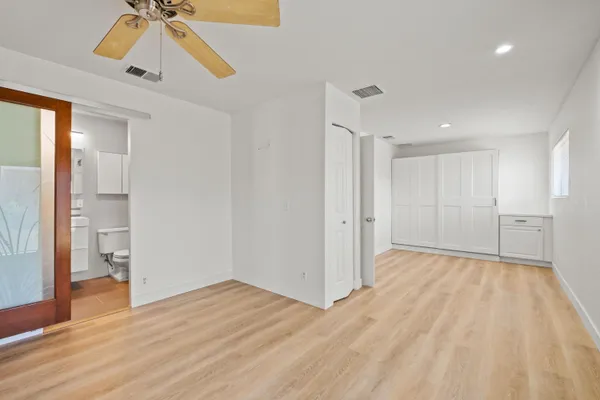a view of empty room with wooden floor