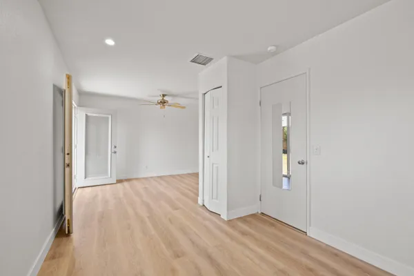 wooden floor in an empty room with a window