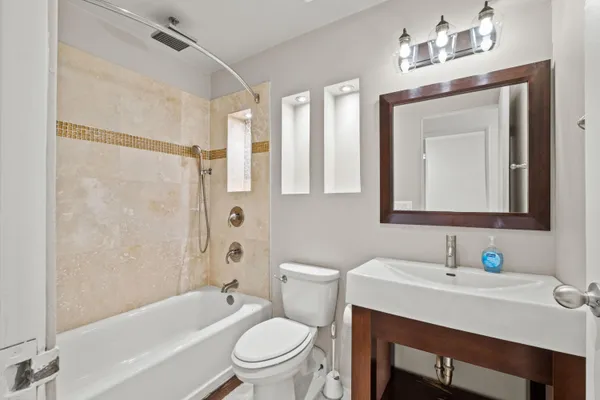 a bathroom with a sink toilet a mirror and shower