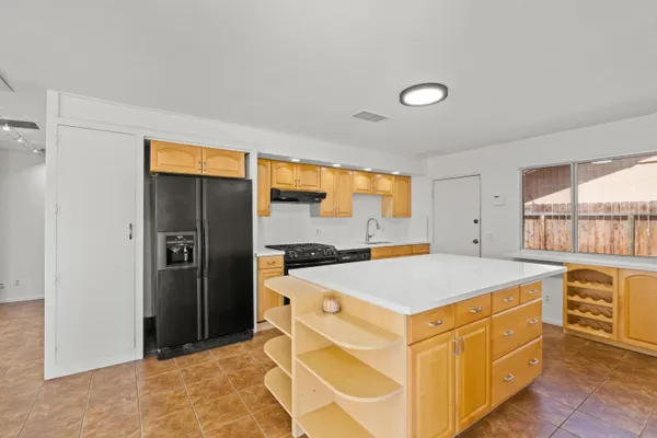a kitchen that has a sink and a refrigerator