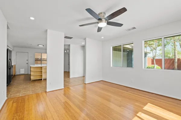 a view of a livingroom with a ceiling fan and window