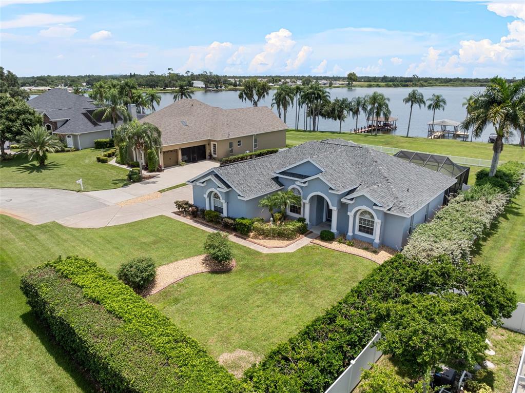 7358 Bent Grass Drive Winter Haven, FL 33884 - Photo 1 of 1 an aerial view of a house with outdoor space and a lake view