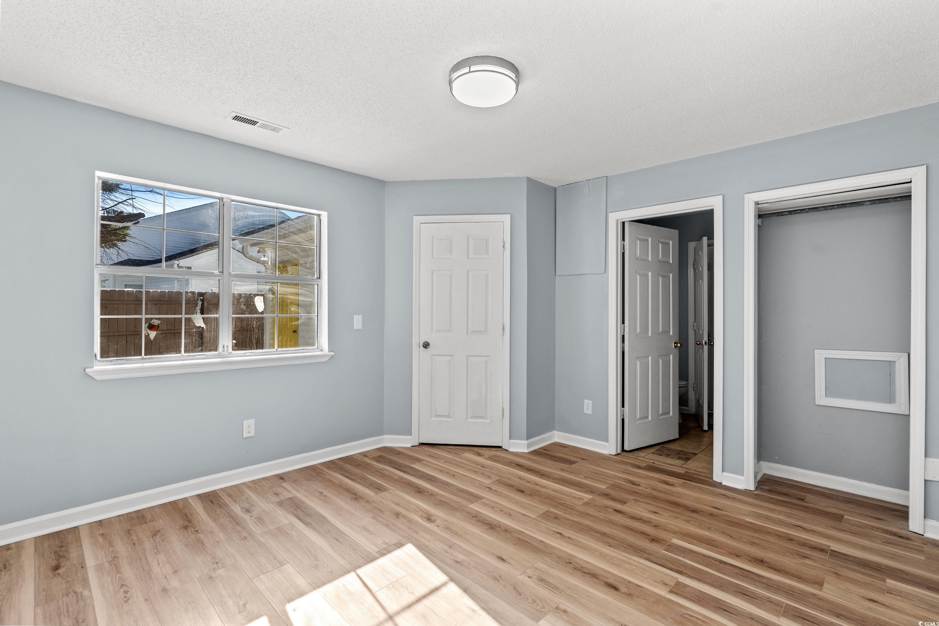 1024 Futrell Drive, Unit 1024 Myrtle Beach, SC 29577 - Photo 12 of 20 Unfurnished bedroom with light hardwood / wood-sty