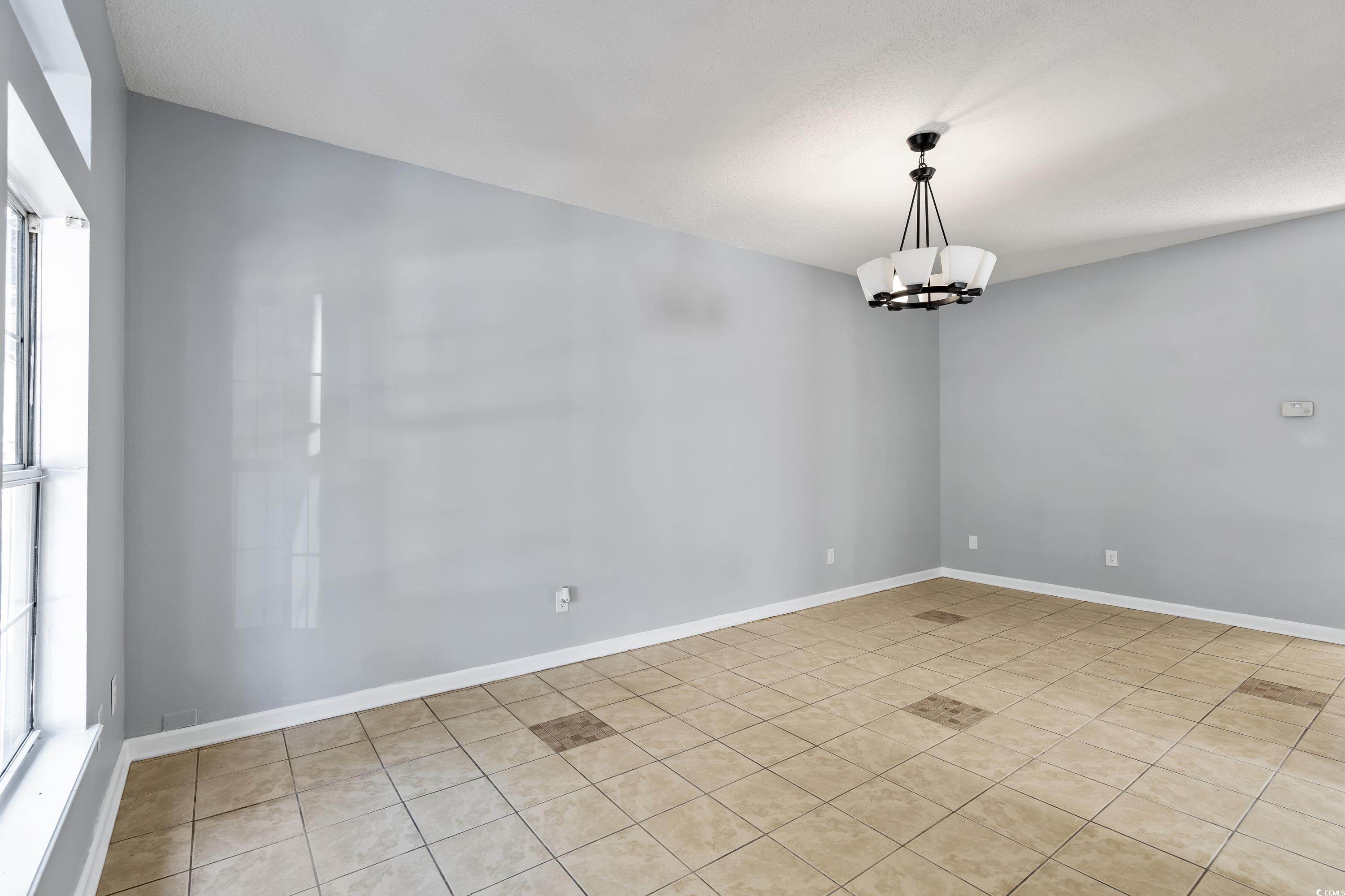 1024 Futrell Drive, Unit 1024 Myrtle Beach, SC 29577 - Photo 18 of 20 Empty room featuring light tile patterned floors a