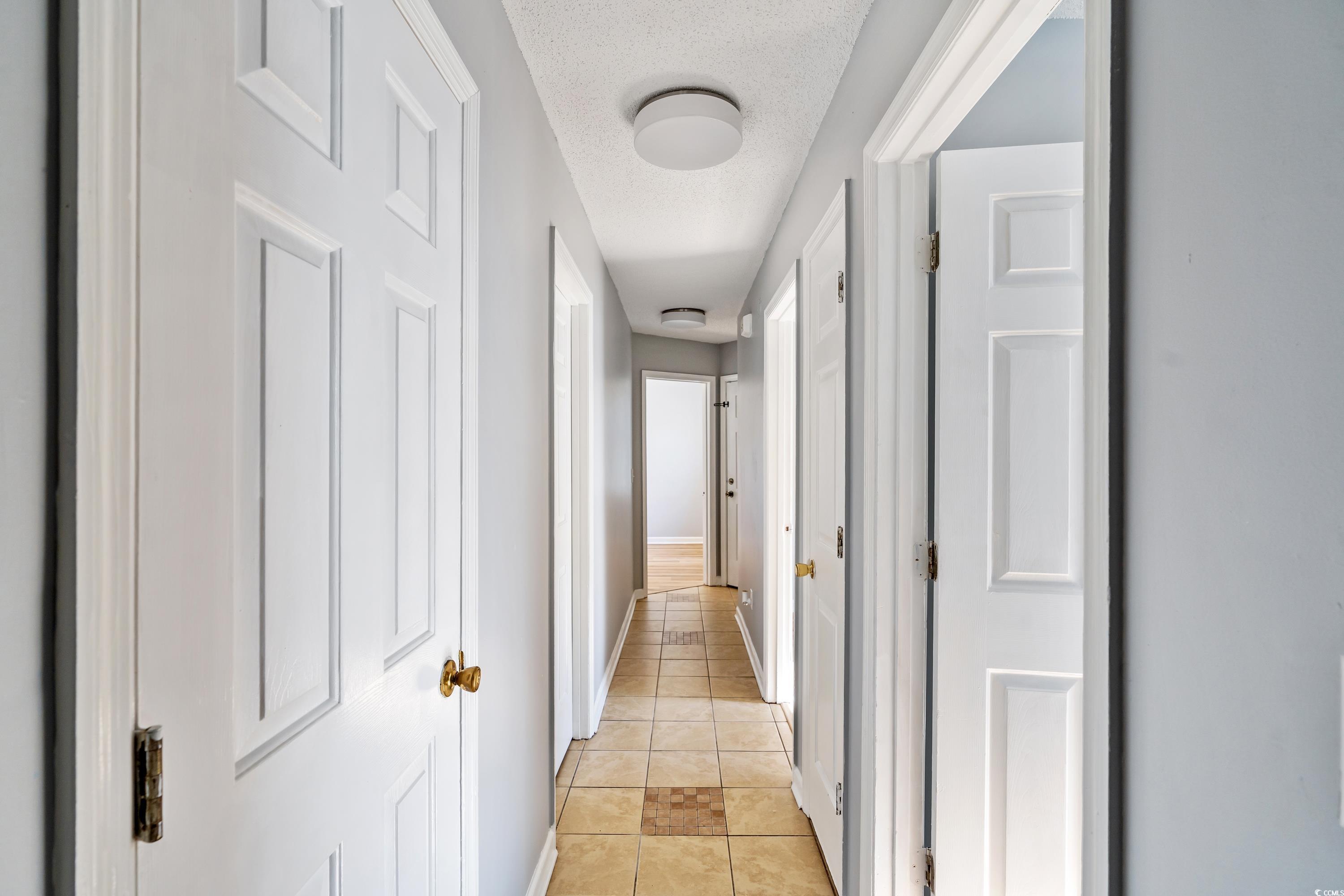 1024 Futrell Drive, Unit 1024 Myrtle Beach, SC 29577 - Photo 19 of 20 Corridor with light tile patterned flooring and a