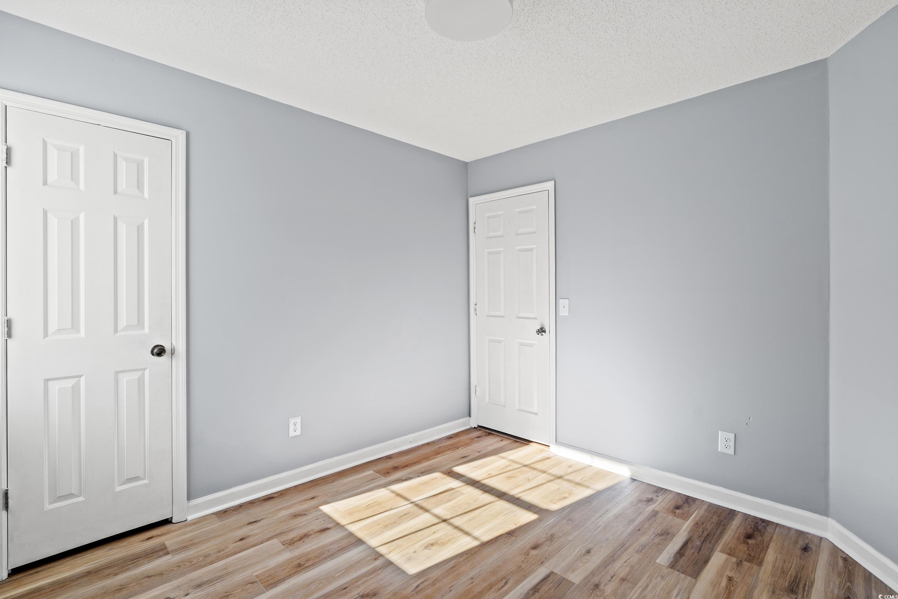 1024 Futrell Drive, Unit 1024 Myrtle Beach, SC 29577 - Photo 8 of 20 Spare room featuring a textured ceiling and light