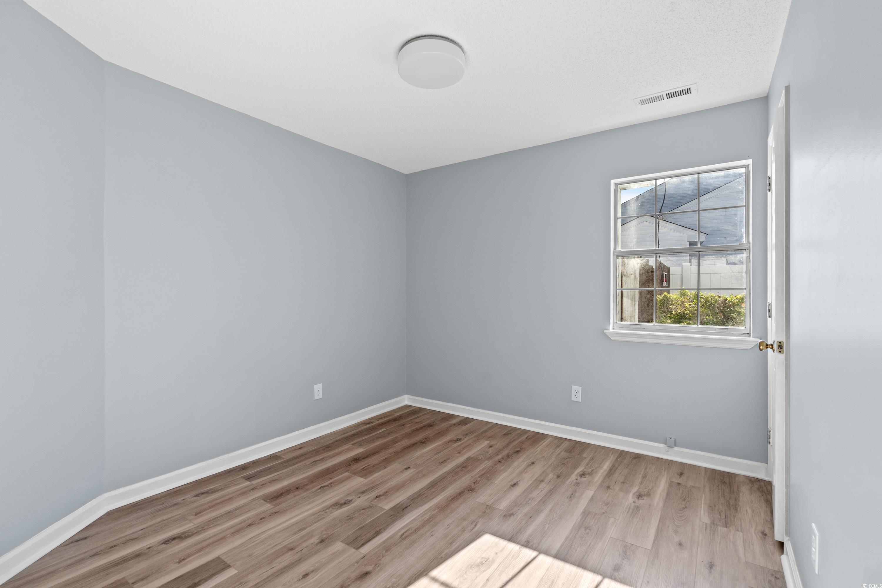 1024 Futrell Drive, Unit 1024 Myrtle Beach, SC 29577 - Photo 9 of 20 Spare room with light hardwood / wood-style floors