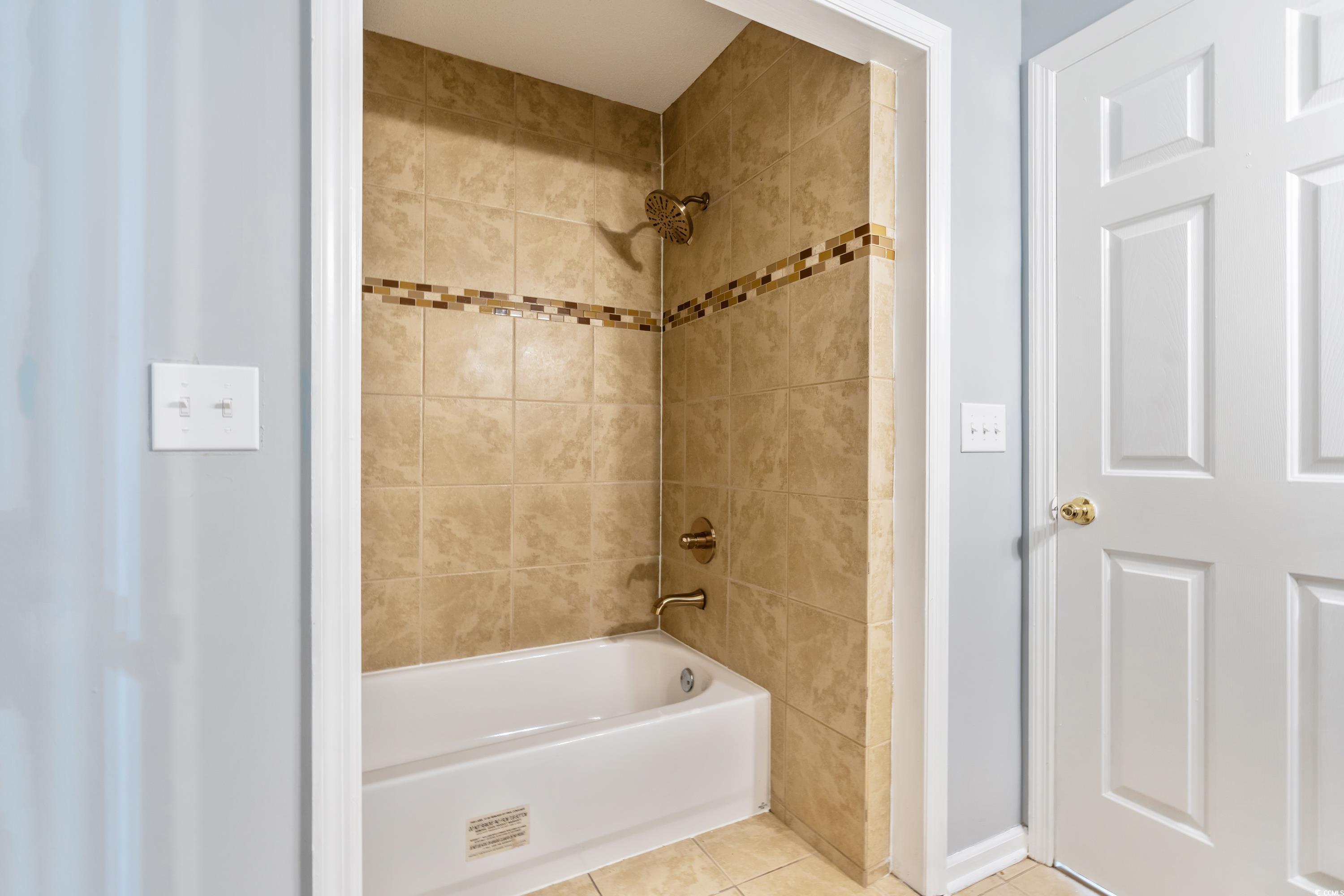 1024 Futrell Drive, Unit 1024 Myrtle Beach, SC 29577 - Photo 10 of 20 Bathroom with tiled shower / bath and tile pattern