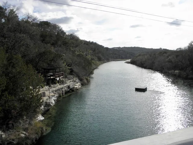 a front view of a house with a yard and lake view