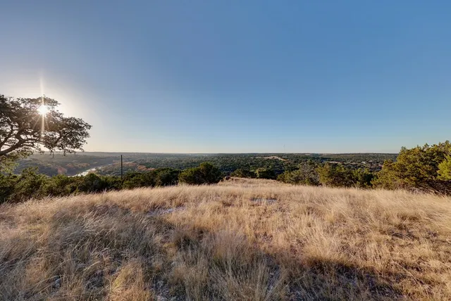 a view of a large body of water with lots of trees in all around