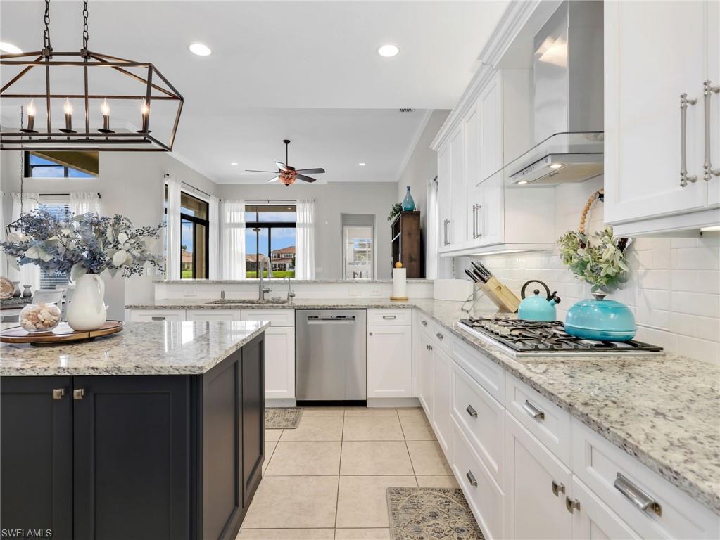 2756 Crystal Way Naples, FL 34119 - Photo 22 of 50 a kitchen with stainless steel appliances granite countertop a sink and cabinets