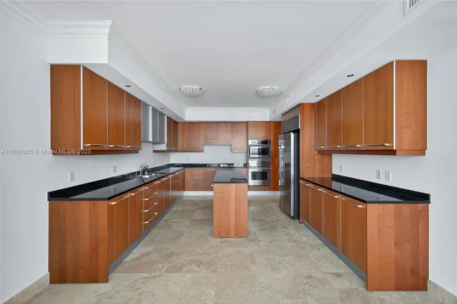 a view of a kitchen with kitchen island a large window cabinets and dining table