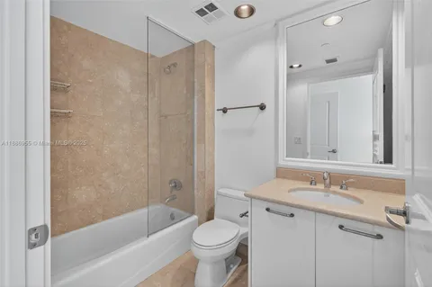 a bathroom with a sink toilet and a mirror