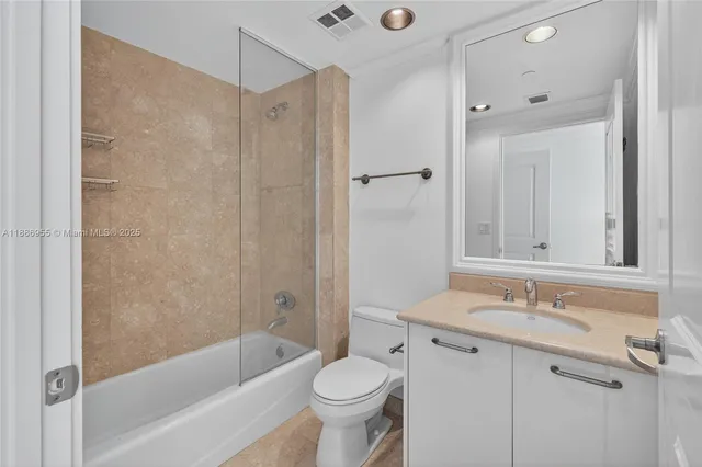 a bathroom with a sink toilet and a mirror