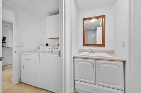 a view of multiple house with a yard and potted plants