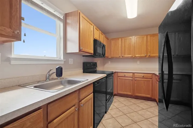a kitchen with a sink stove and refrigerator