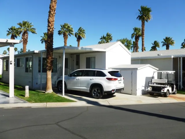 a view of a car parked in front of a house
