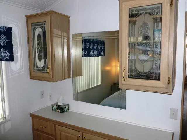 a bathroom with a mirror sink and glass door