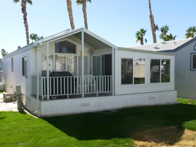 a view of a house with backyard and porch