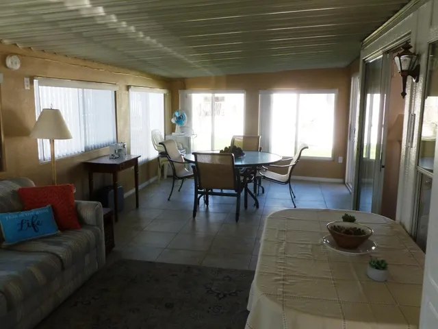 a dining room with furniture and a chandelier