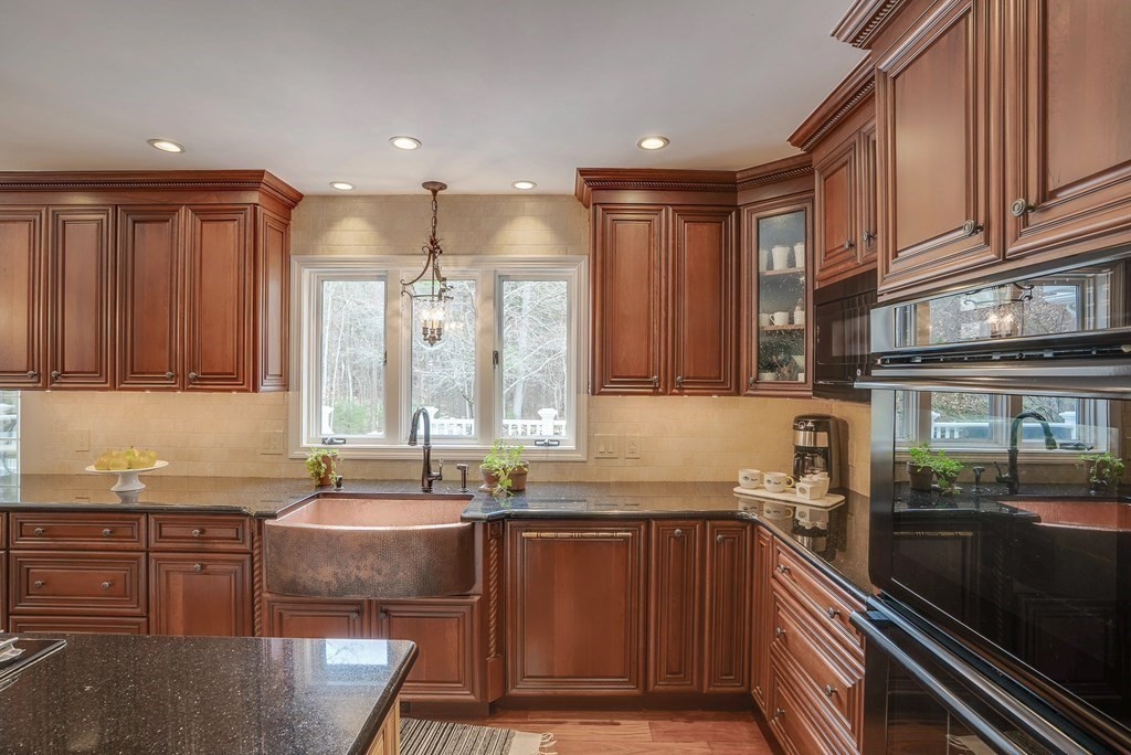 4 Paddock Lane Andover, MA 01810 - Photo 11 of 42 a kitchen with granite countertop a sink stove and cabinets