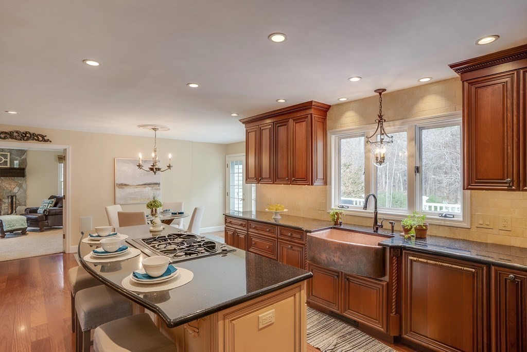 4 Paddock Lane Andover, MA 01810 - Photo 12 of 42 a kitchen with kitchen island granite countertop a sink and stove