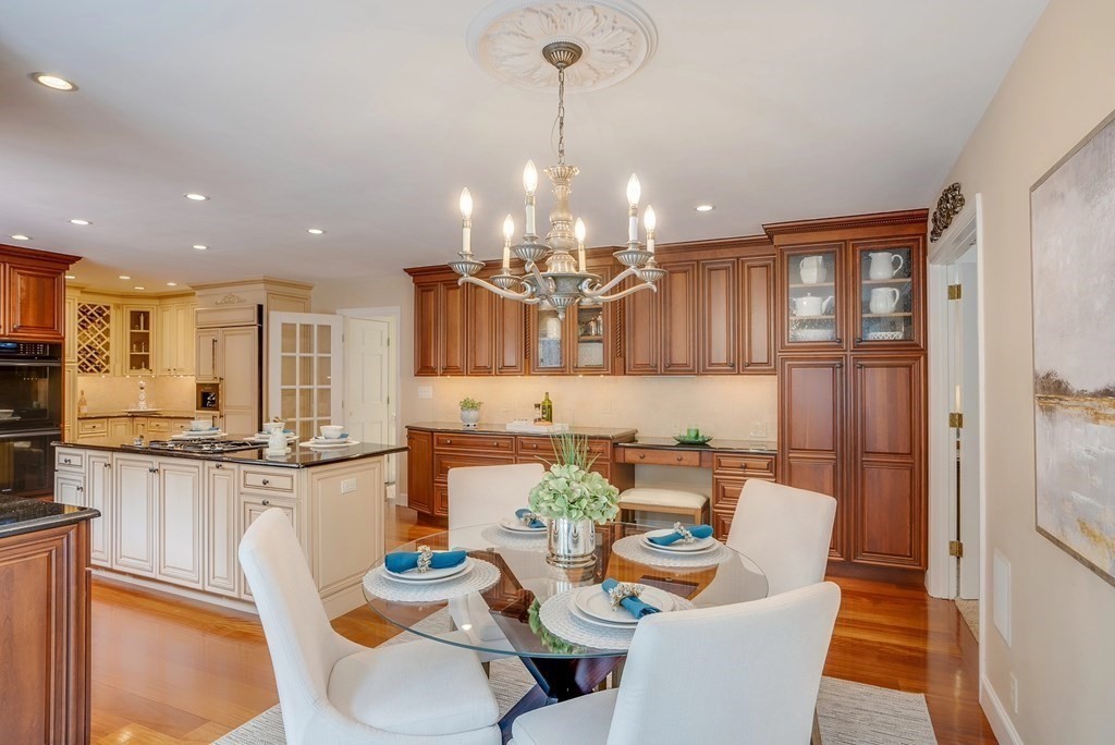 4 Paddock Lane Andover, MA 01810 - Photo 15 of 42 a view of a dining room with furniture a kitchen and chandelier