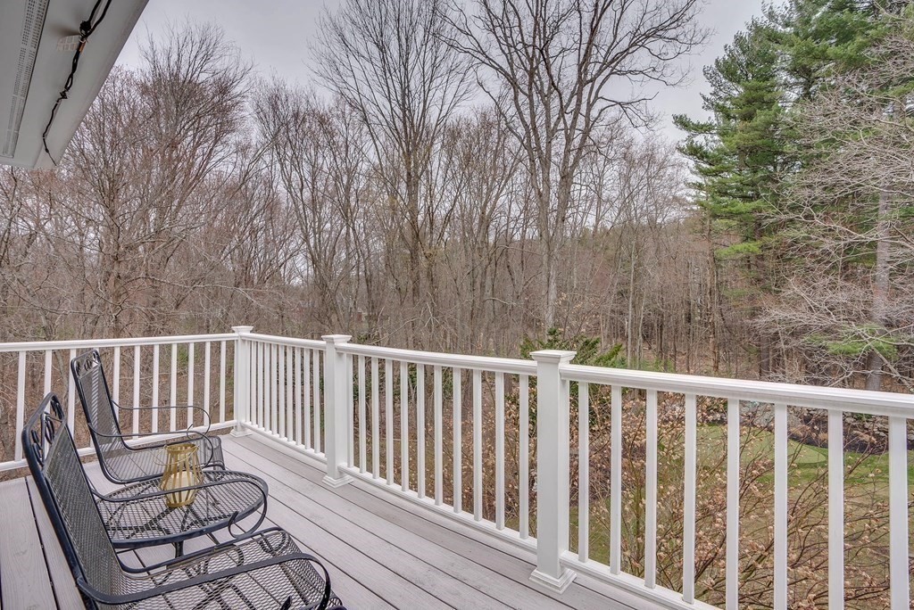 4 Paddock Lane Andover, MA 01810 - Photo 31 of 42 a porch with a bench next to a yard