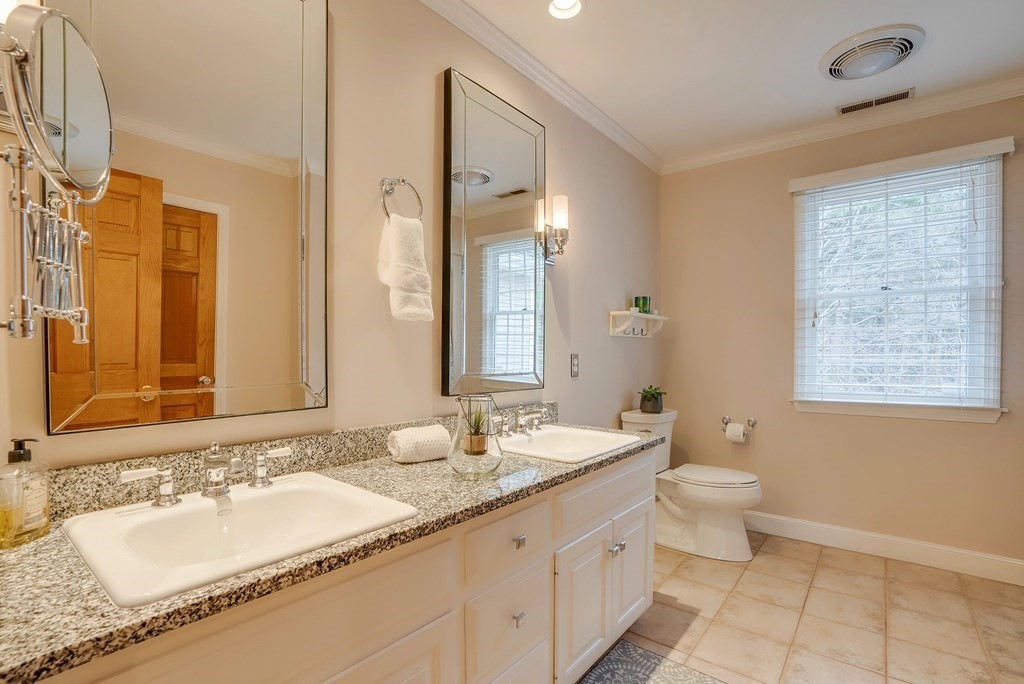 4 Paddock Lane Andover, MA 01810 - Photo 32 of 42 a bathroom with a granite countertop double vanity sinks a mirror and a bathtub