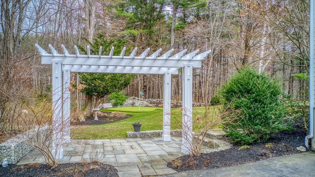 4 Paddock Lane Andover, MA 01810 - Photo 4 of 42 a front view of a house with garden