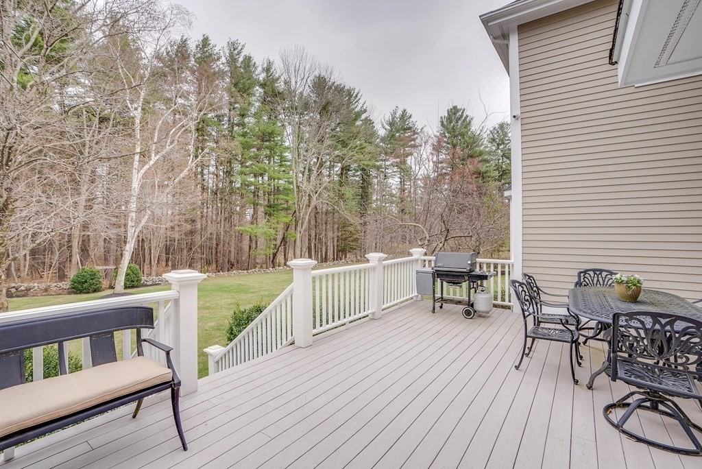 4 Paddock Lane Andover, MA 01810 - Photo 6 of 42 a balcony with wooden floor table and chairs