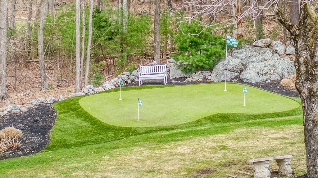 4 Paddock Lane Andover, MA 01810 - Photo 7 of 42 a view of a swimming pool with a yard and large trees