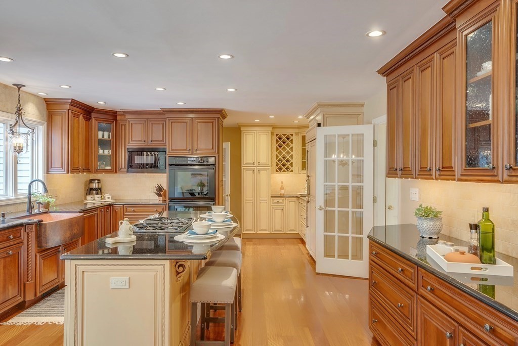 4 Paddock Lane Andover, MA 01810 - Photo 9 of 42 a kitchen with stainless steel appliances granite countertop a sink stove and refrigerator
