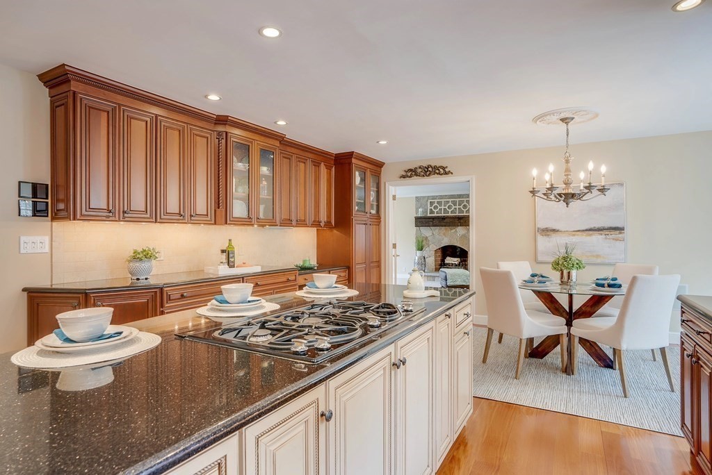 4 Paddock Lane Andover, MA 01810 - Photo 10 of 42 a kitchen with a table chairs stove and cabinets