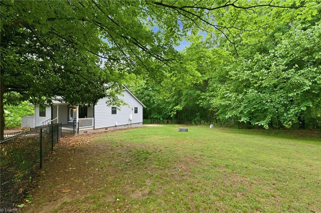 3546 Lewiston Road Greensboro, NC 27410 - Photo 31 of 32 View of the fenced in area of the back and side yard.
