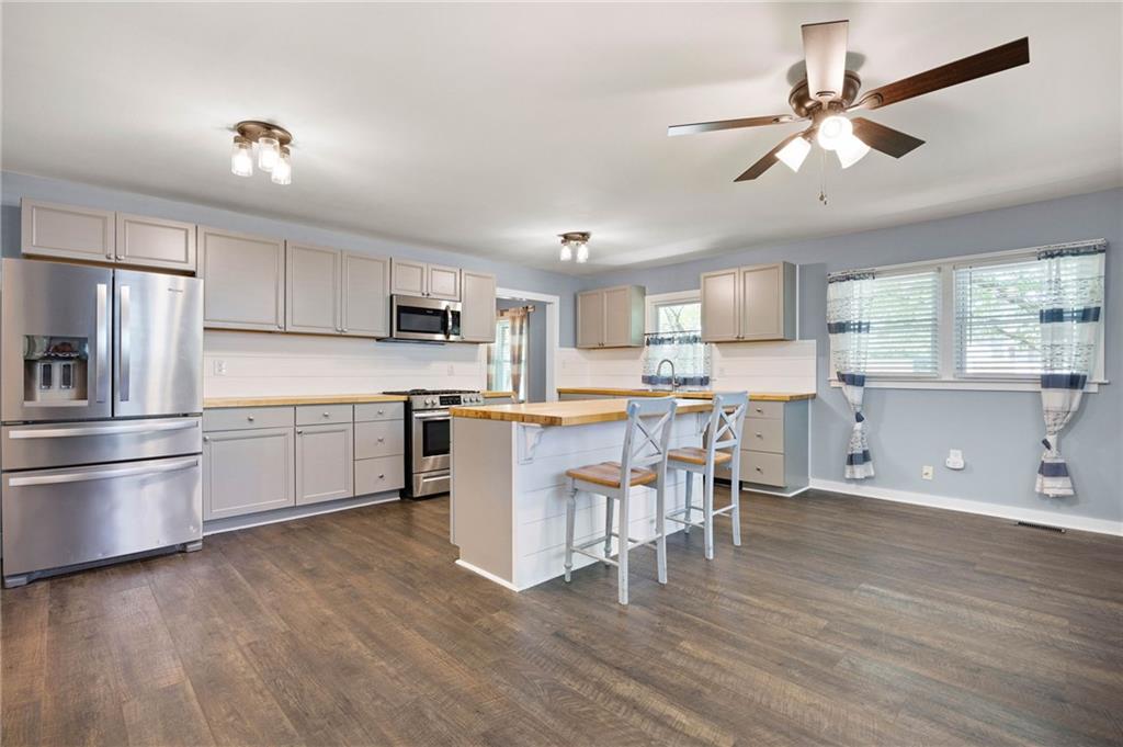 3871 Furr Avenue Powder Springs, GA 30127 - Photo 11 of 32 a open kitchen with white cabinets and stainless steel appliances