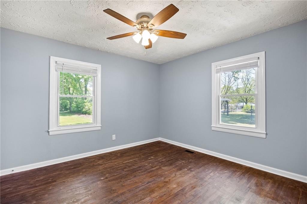 3871 Furr Avenue Powder Springs, GA 30127 - Photo 21 of 32 a view of an empty room with wooden floor and a window