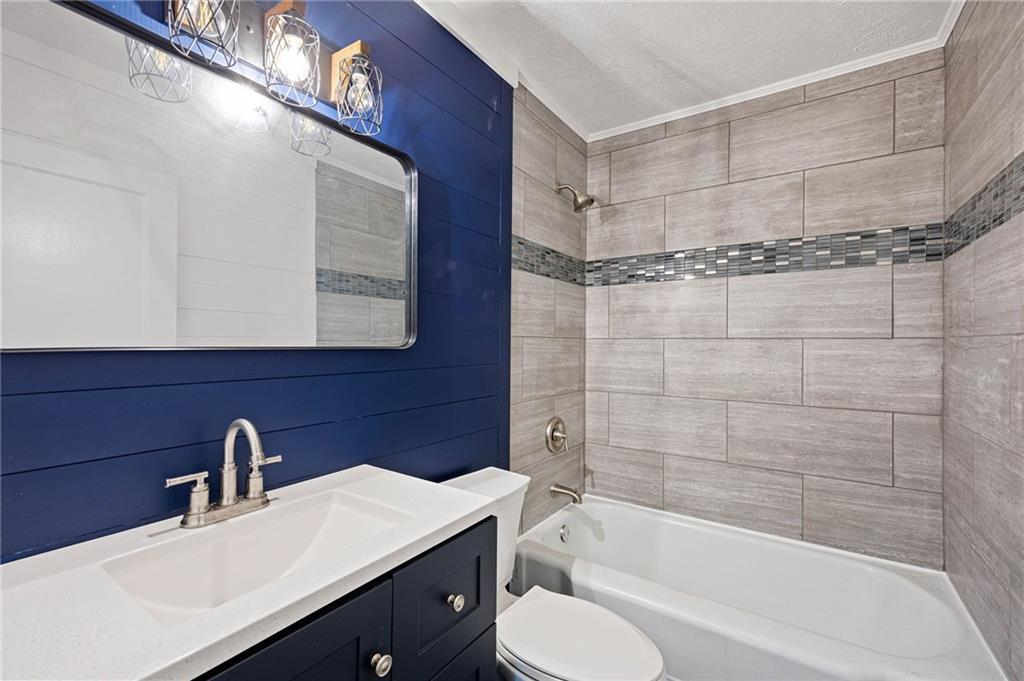 3871 Furr Avenue Powder Springs, GA 30127 - Photo 22 of 32 a bathroom with a bathtub shower sink vanity and toilet