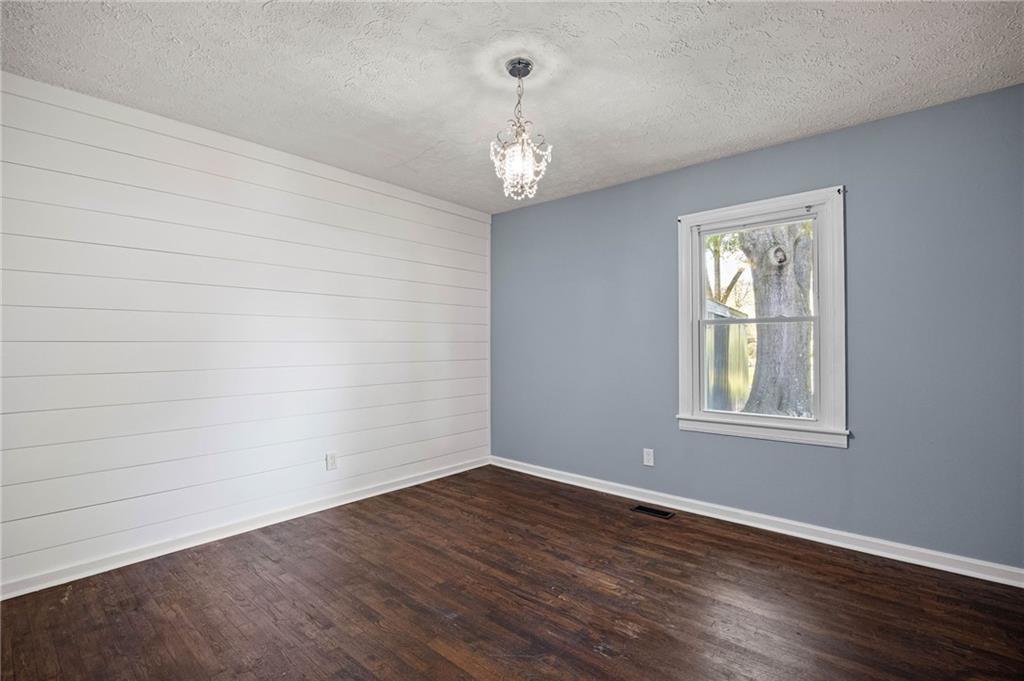 3871 Furr Avenue Powder Springs, GA 30127 - Photo 23 of 32 a view of an empty room with wooden floor and a window