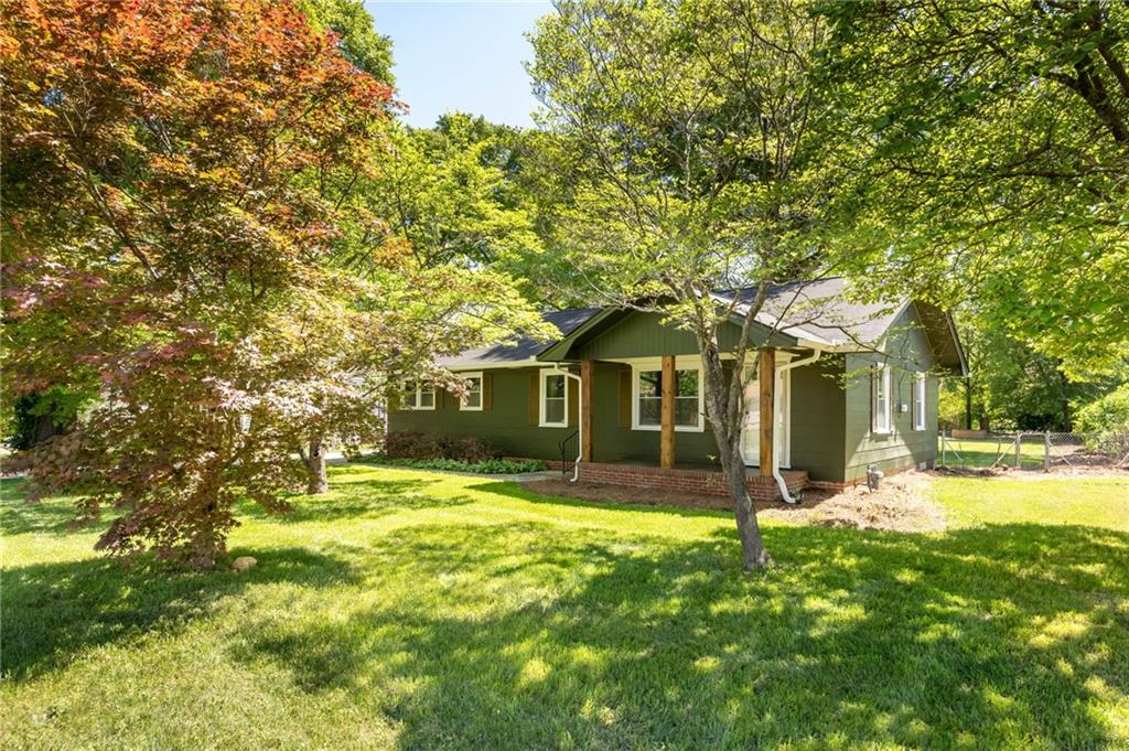 3871 Furr Avenue Powder Springs, GA 30127 - Photo 29 of 32 a front view of a house with a garden