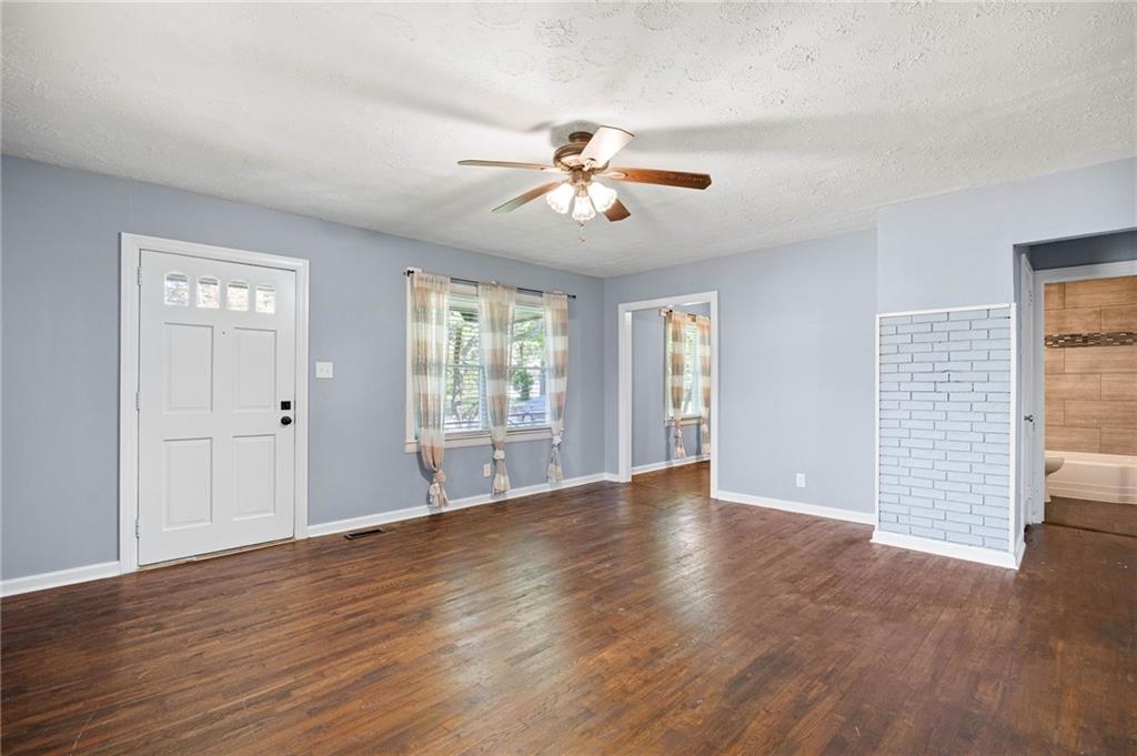 3871 Furr Avenue Powder Springs, GA 30127 - Photo 6 of 32 a view of an empty room with a window and wooden floor