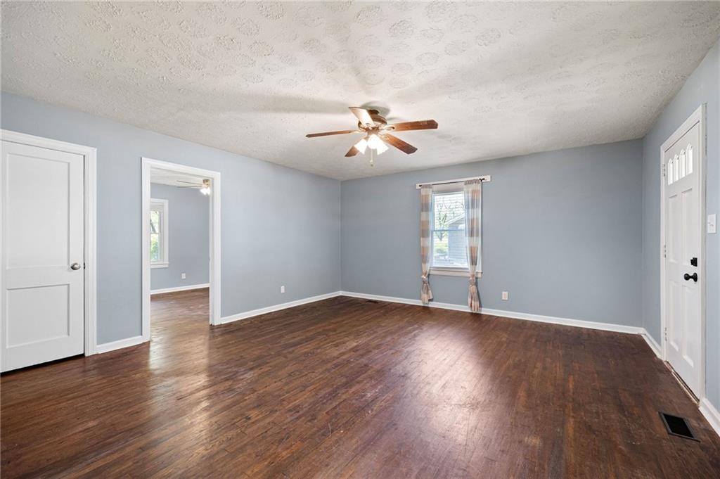 3871 Furr Avenue Powder Springs, GA 30127 - Photo 7 of 32 an empty room with wooden floor and windows