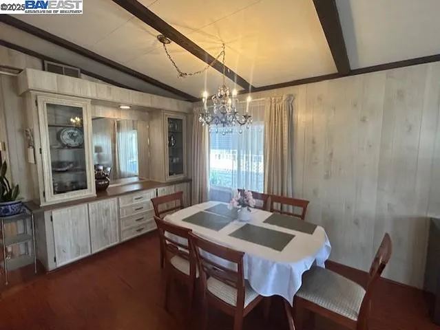 a kitchen with a table chairs and wooden floor
