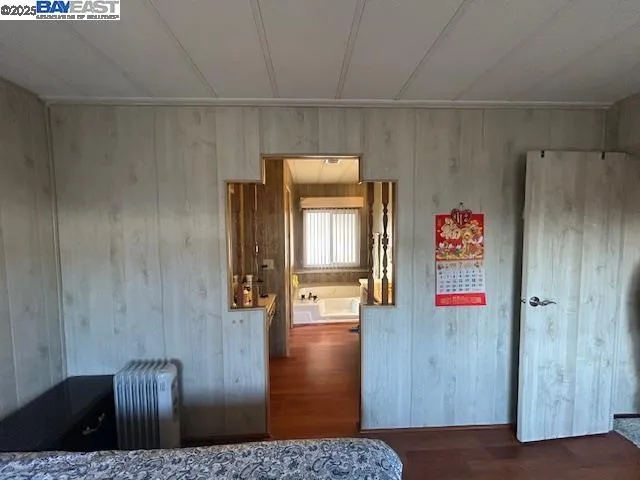 a bed sitting in a bedroom and chair