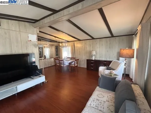 a living room with couches and a fireplace with wooden floor