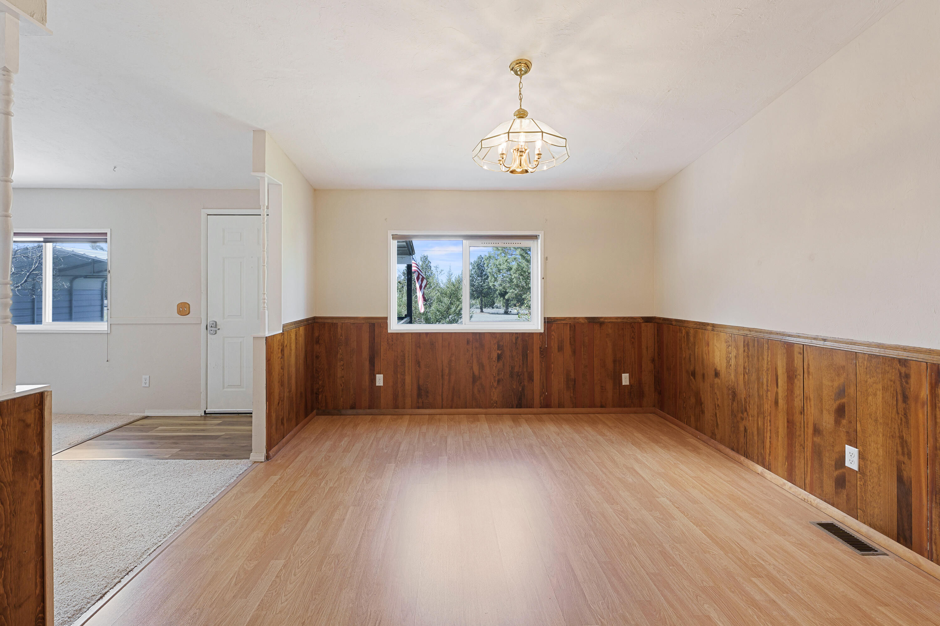 5674 Southeast Davis Loop Prineville, OR 97754 - Photo 15 of 48 a view of an empty room with wooden floor and a window