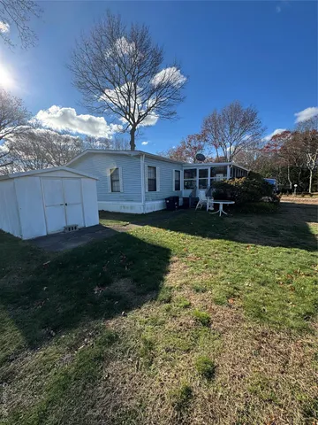 a view of a yard with a large tree